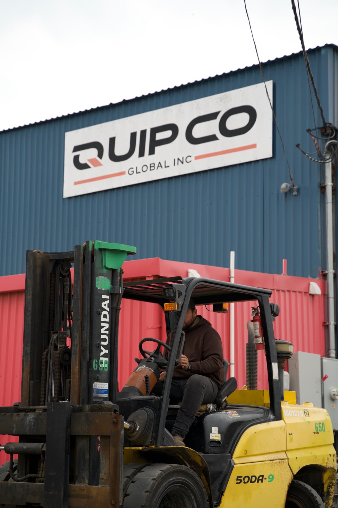 Forklift operating outside the QuipCo Global Inc facility
